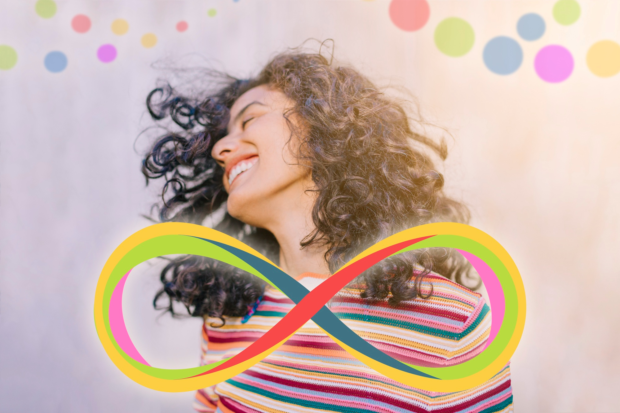 Smiling neurodivergent woman with a colorful infinity symbol for NDFriends, an autism and neurodivergent dating app